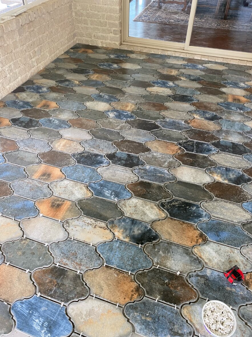 Close-up of multicolored interlocking pavers during installation